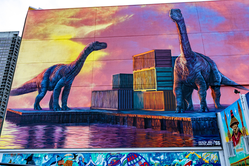 Jurassic Port mural shows dinosaurs and shipping containers as part of a working waterfront.