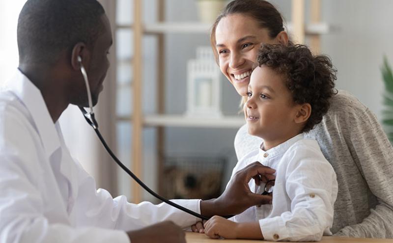 Doctor listening to child's heart.