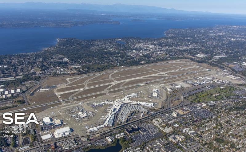 Aerial view of SEA Airport, with the SEA logo superimposed on it