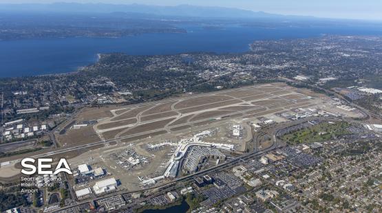 Aerial view of SEA Airport, with the SEA logo superimposed on it