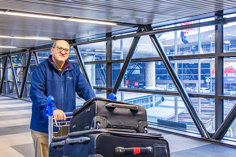 Andy Carrol on an SEA skybridge delivering luggage to the airport