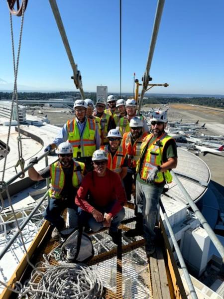 Photo of John Watson, second from the right leaning down, and the Superintendent project team