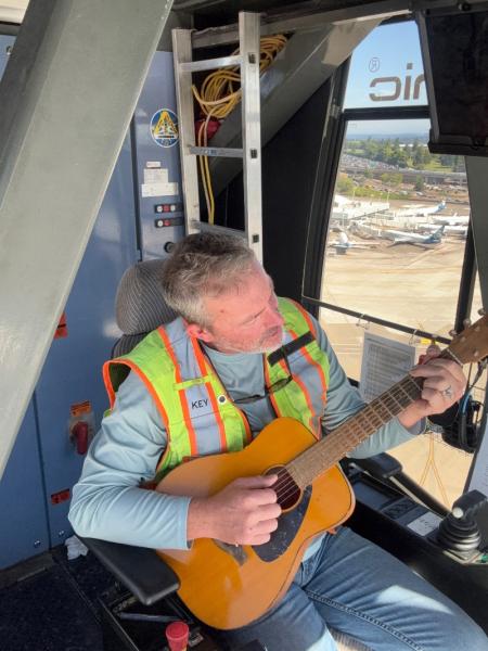 Mike Key strums his guitar on breaks