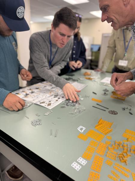 The project team assembles a toy crane