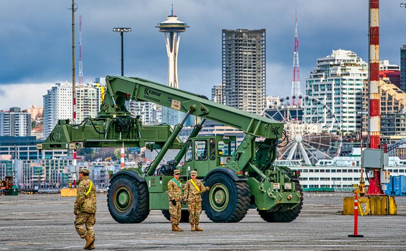 Members of the military oversee equipment at Terminal 46 in preparation to set up a field hospital at Century Quest Events Center, April 1, 2020
