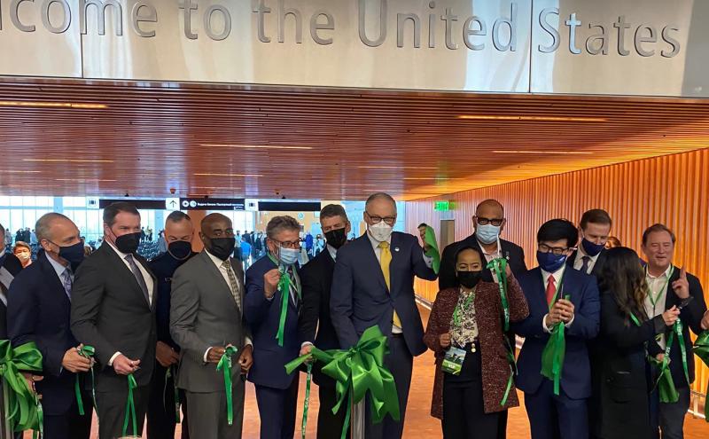 A cadre of leaders including Port Executive Director Metruck, SEA Managing Director Lyttle, Commissioners Felleman, Mohamed, Cho, and Calkins, and WA State Governor Inslee