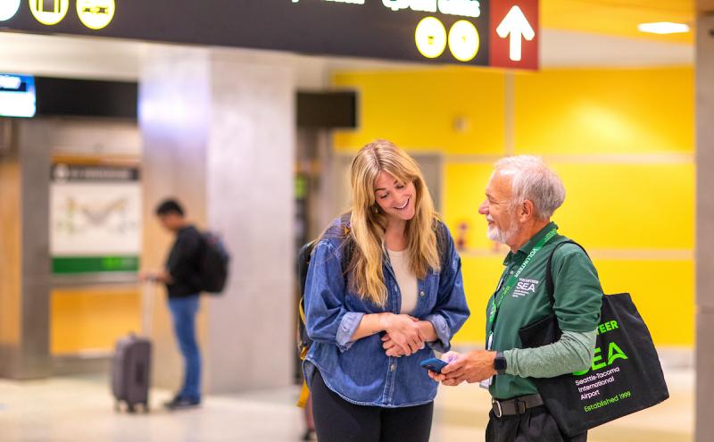 Volunteer helping a customer.