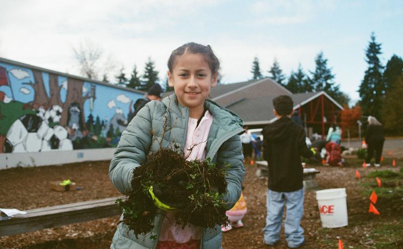 Seahurst Elementary student works in a rain garden at the school