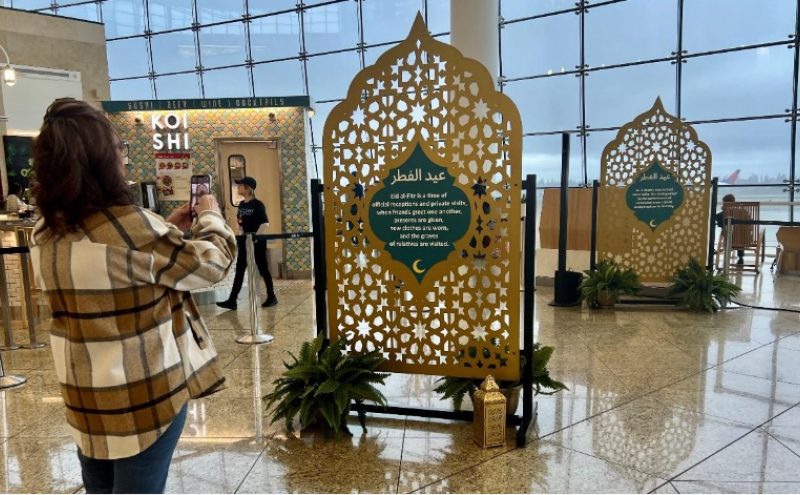 Image of customer taking a photo of Eid Al-Fitr displays in the central terminal