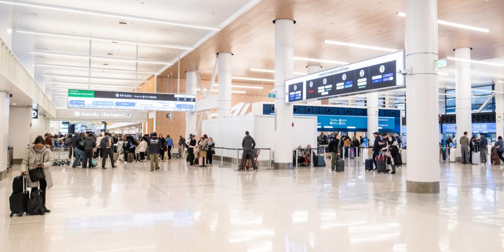 Travelers moving through the newly remodeled north end of SEA Airport's main terminal