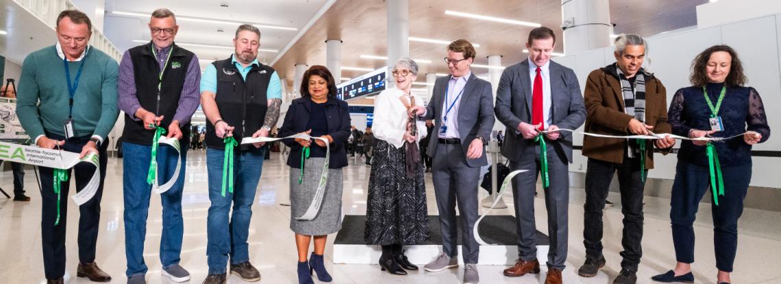 Representatives from the Port of Seattle, Alaska Airlines, and Hensel Phelps cut the ribbon at the SEA Gateway Project's Grand Opening recognition event