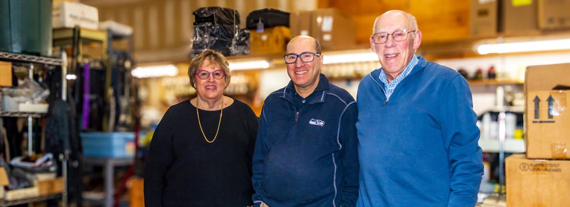 Gayle, Andy, and Joe Carrol inside TW Carrol, their luggage repair shop