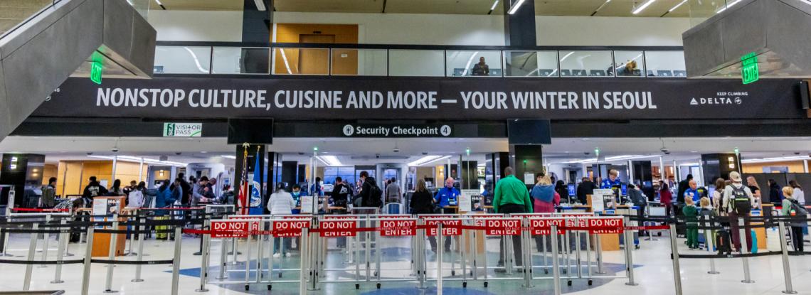 Travelers waiting in line at Checkpoint 4 at SEA Airport